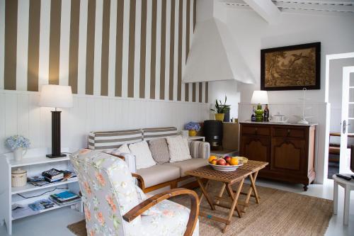 a living room with a couch and a table at Casa Vitoriana in Ponta Delgada