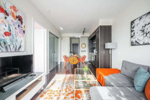 a living room with a couch and a table at Bright High Floor1 Bedroom Condo Downtown Toronto in Toronto
