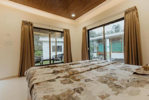 Кровать или кровати в номере Kaustubh farm by Classy stay