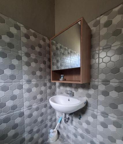 a bathroom with a sink and a mirror at Bumbab House by Pigeon in Nusa Dua