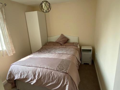 a small bedroom with a bed and a night stand at Friars terrace in Stafford