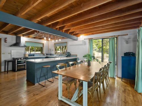 a kitchen with a table and chairs in a room at Mount Buller Summer & Ski Holiday House The Bower in Merrijig