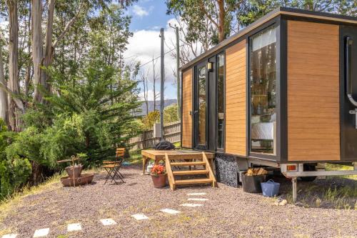 a tiny house sitting on top of a gravel yard at Cygnet Valley Hideaway by Tiny Away in Cygnet