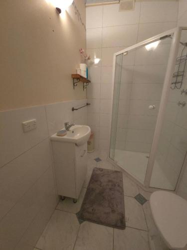 a bathroom with a shower and a toilet and a sink at Nottingham way Homestay in Blackwood