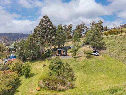 an overhead view of a house on a grassy hill at Cygnet Valley Hideaway by Tiny Away in Cygnet