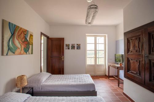 a bedroom with two beds and a desk and a window at AMERICA NEI BOSCHI B&B in Bra