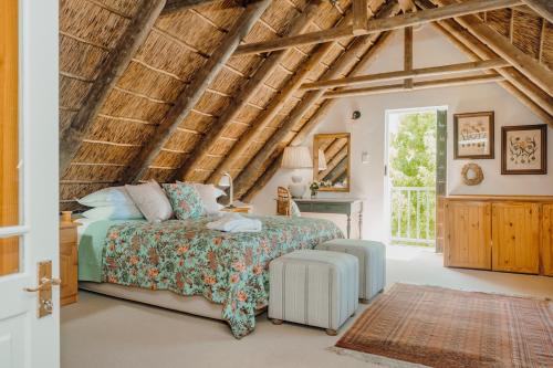 a bedroom with a bed and a desk and a window at Dove Cottage in Stanford