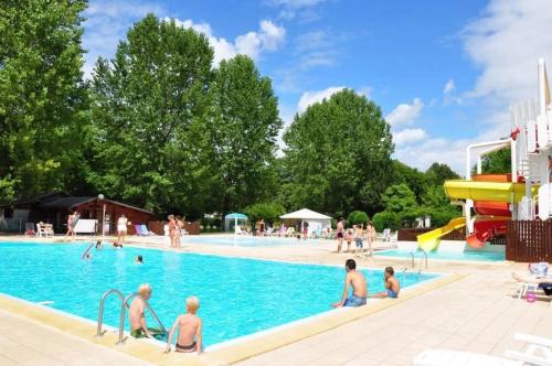 a group of people in a swimming pool at ZEcamping 4 étoiles parc aquatique restaurant et parcours de pêche au fouet in Argentat