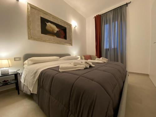a bedroom with a bed with two towels on it at Il Campanile 2 in Fondi