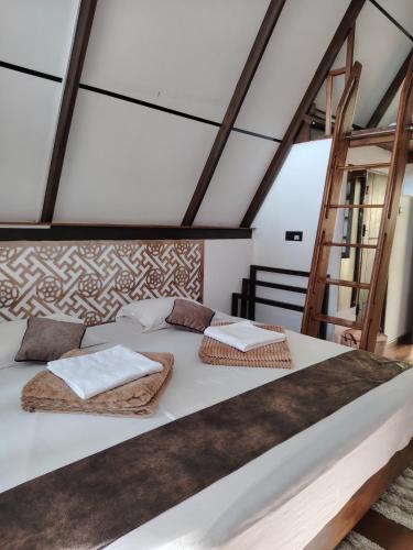 a bedroom with a large white bed with two pillows at Hideout Galle in Galle