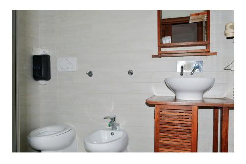 a bathroom with a toilet and a sink at La Dolce Sosta in Lido di Ostia