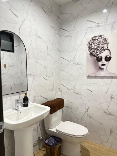a white bathroom with a sink and a toilet at Rivla A Pool Villa in Ao Nang 