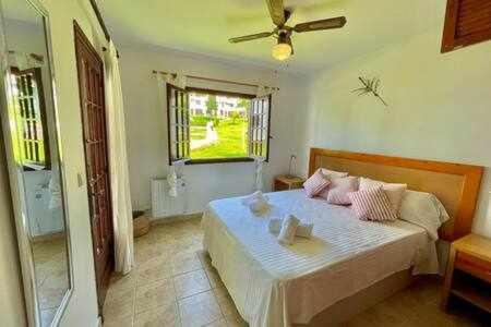 a bedroom with a bed with a ceiling fan at SON BOU Apartamento en planta baja junto la playa in Son Bou