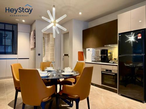 a kitchen and dining room with a table and chairs at Antara Genting by HeyStay Management in Genting Highlands