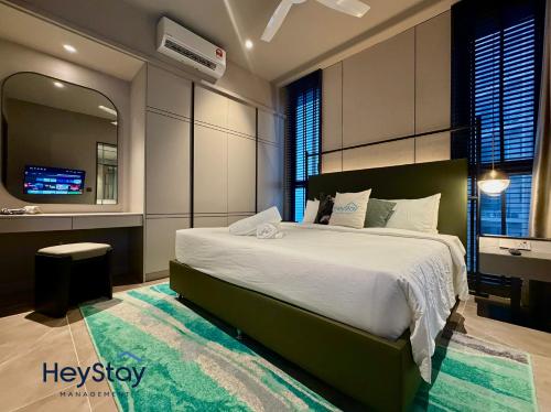 a bedroom with a bed and a mirror and a television at Antara Genting by HeyStay Management in Genting Highlands