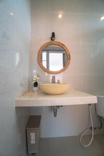 a bathroom with a sink and a mirror at Villa cassia in Kerobokan