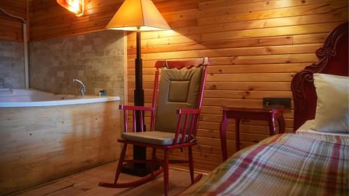 a bedroom with a bed and a chair and a tub at Treetops Park Hotel in Sile