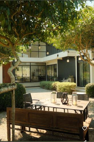 a table and chairs in front of a building at THE OAK’S in Chiang Rai