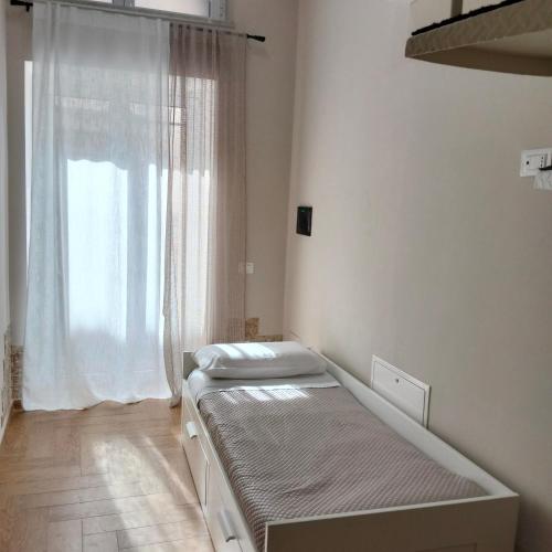 a bedroom with two beds and a window at Divingreta 1820 in Ottaviano