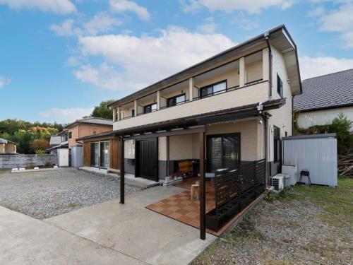 a house with a large driveway in front of it at 月兎園 in Yoshioka