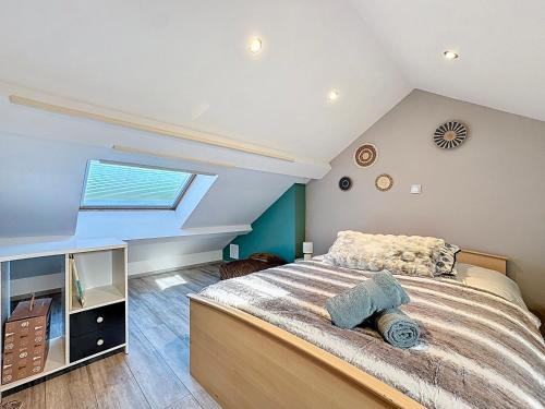 a bedroom with a large bed and a window at Dune Marchande - Séjour Cozy in Bray-Dunes
