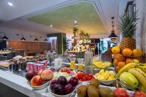 a buffet of fruits and vegetables on a table at Hotel Cuevas - Adults Only in Santillana del Mar