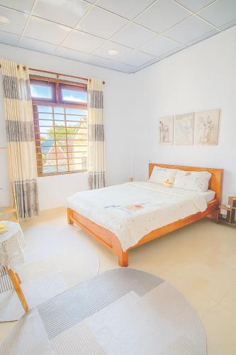 a bedroom with a large bed in a room at Sim House in Hue