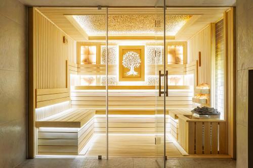 a sauna with a glass door in a room at Silk Road Tashkent in Tashkent