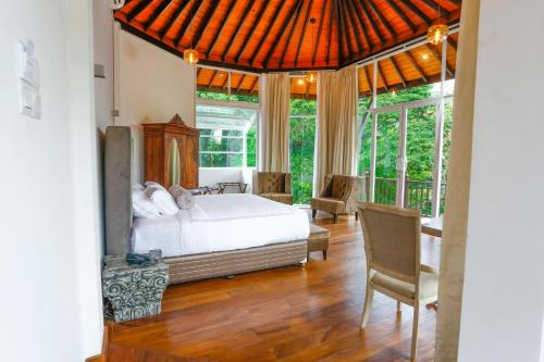a bedroom with a bed and a large window at Viyana Boutique Hotel in Kandy