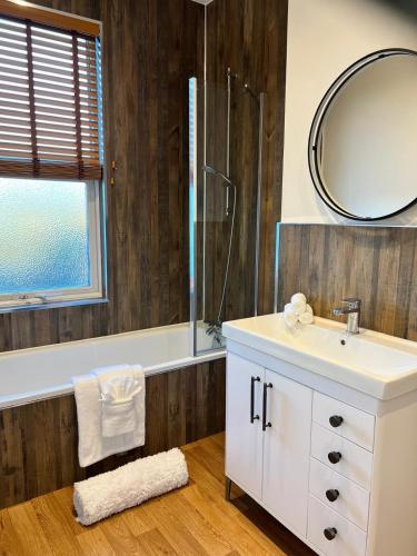 a bathroom with a sink and a shower and a mirror at 180b Wells Road in Bristol