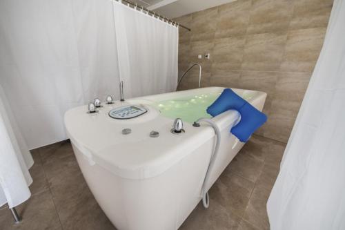 a white bath tub in a bathroom with a sink at Apartmán v Barónke in Púchov