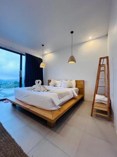 a bedroom with a bed with a ladder in it at Pinggan harmoni in Baturaja