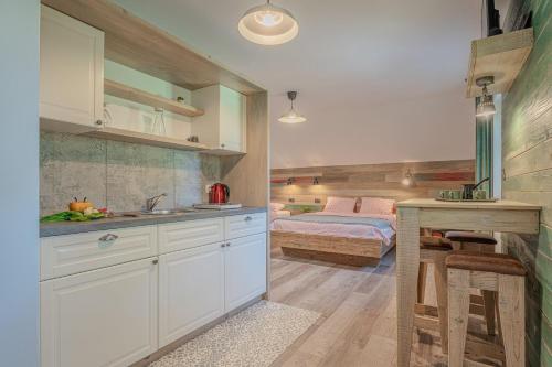 a kitchen with a sink and a bed in a room at Lukec Estate in Kostel