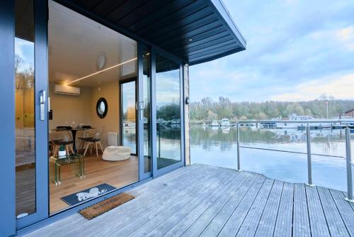 a house with a view of the water at Boat'n Flandres - Houseboat rooftop proche Lille in Deûlemont