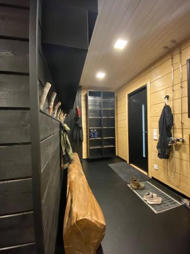 a hallway with a closet with a bag on the wall at Arctic Skyline Villa in Pudasjärvi