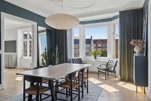 a dining room with a large wooden table and chairs at Charming Luxury Flat Nørrebro I Super Rare Find in Copenhagen