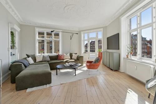 a living room with a couch and a table at Charming Luxury Flat Nørrebro I Super Rare Find in Copenhagen