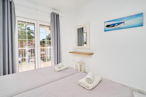 a bedroom with a large bed with two pillows on it at Apto 2 Almoraide Suites in Nerja