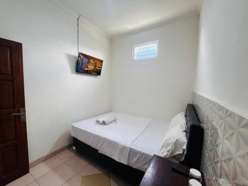 En eller flere senge i et værelse på CQA Living TANA 1 By ARBA