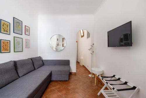 a living room with a couch and a flat screen tv at La Casetta di Via Sannio in Rome