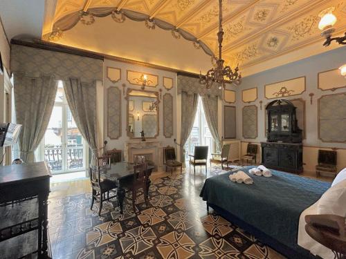 a bedroom with a bed and a desk and a mirror at Carafa di Maddaloni Residenza di Charme in Naples