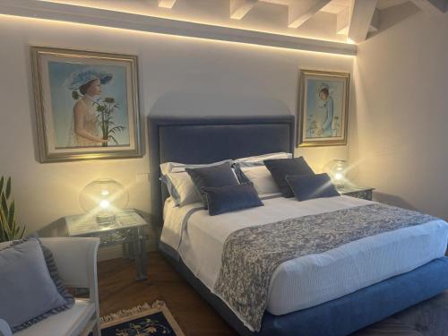 a bedroom with a bed and two pictures on the wall at My Maison 49 in Empoli