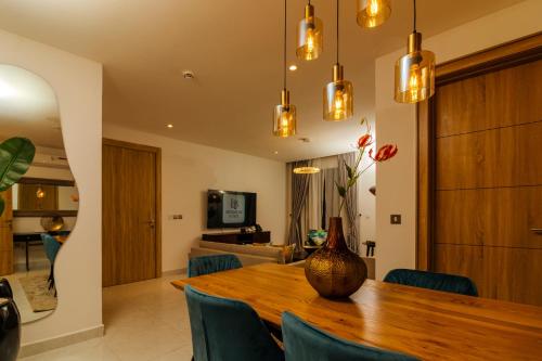 a vase sitting on a wooden table in a living room at Orbit Apartments in Lagos