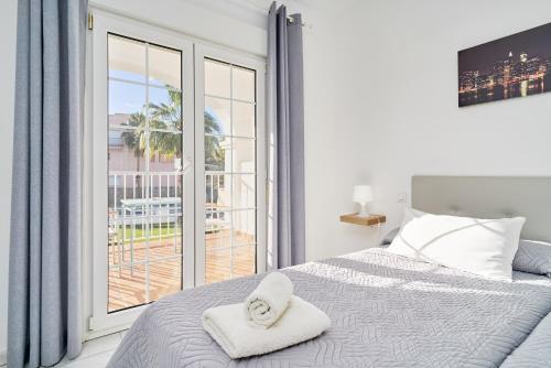 a bedroom with a bed with a towel on it at Apto 1 Almoraide Suites in Nerja