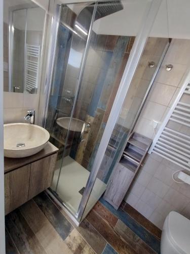 a bathroom with a shower and a sink at Alba e Colori di Puglia in Conversano