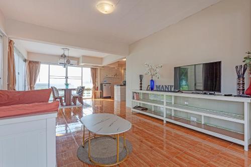 a living room with a couch and a table at The Galvis Pool Villa - Boutique Stay Near Na Jomtien Beach in Na Jomtien