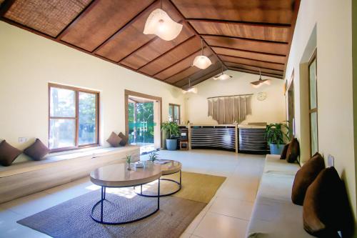 a living room with a table and a couch at Chitwan Paradise Hotel in Sauraha