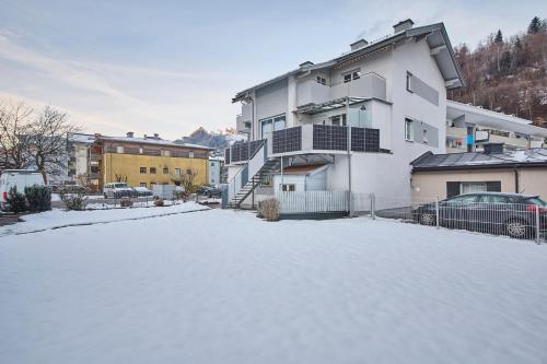 a snow covered parking lot in front of a building at Apartment Sandra in Schwarzach im Pongau