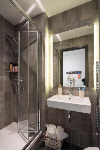 a bathroom with a sink and a shower at Aspen - Airport & City Access in Dublin
