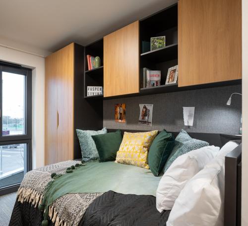 a bedroom with a bed with pillows on it at Aspen - Airport & City Access in Dublin